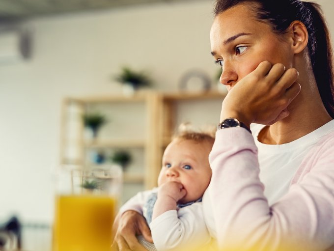 Young mother feeling worried and thinking of something at home.